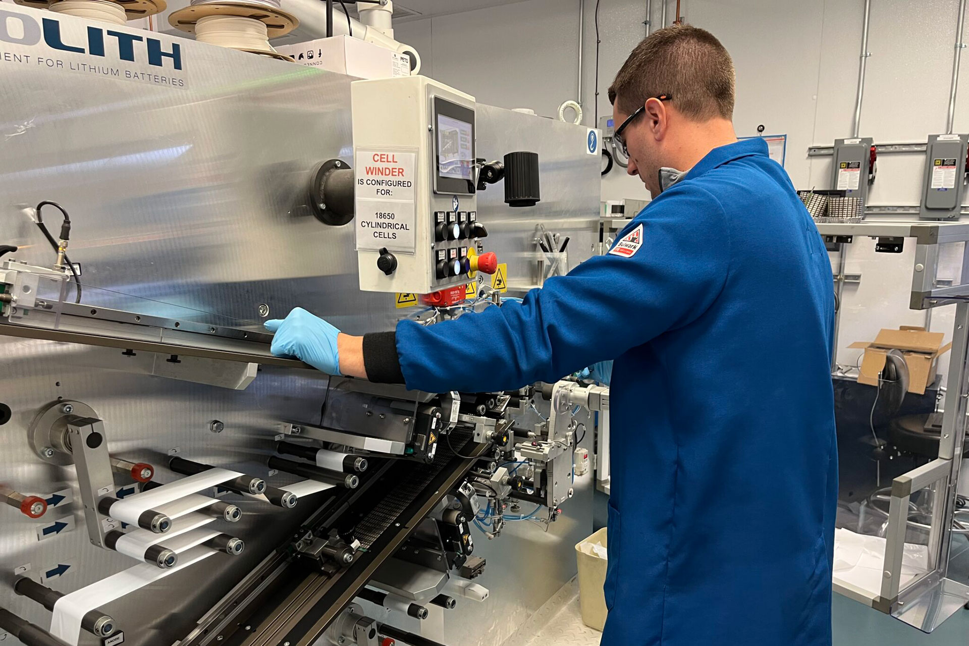 Person operating industrial equipment in a laboratory setting